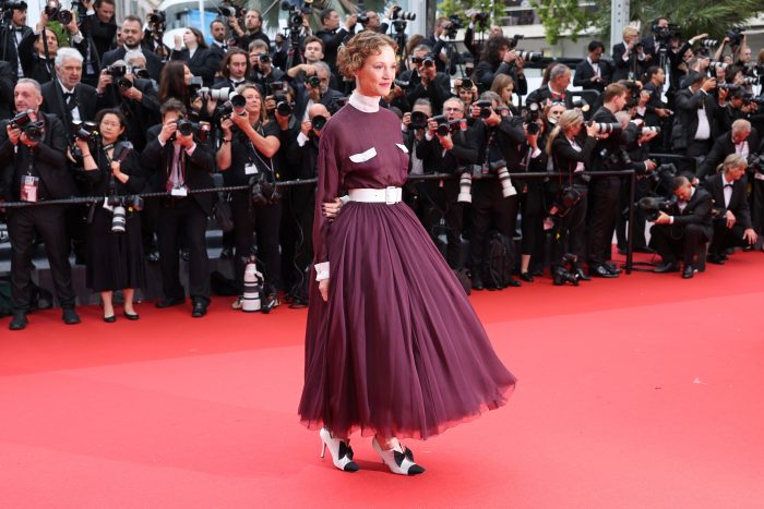 Lors de la cérémonie d'ouverture du Festival de Cannes 2024, Vicky Krieps, porte une robe jupon ceinturée en mousseline prune, look 51, de la collection Haute Couture automne-hiver 2019/20.